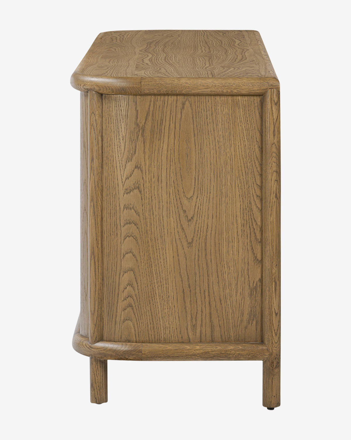 Side view of the Rolette Sideboard in natural oak, showing visible wood grain, rounded edges, gunmetal door pulls, and short cylindrical legs. Displayed against a plain white background, by McGee & Co.