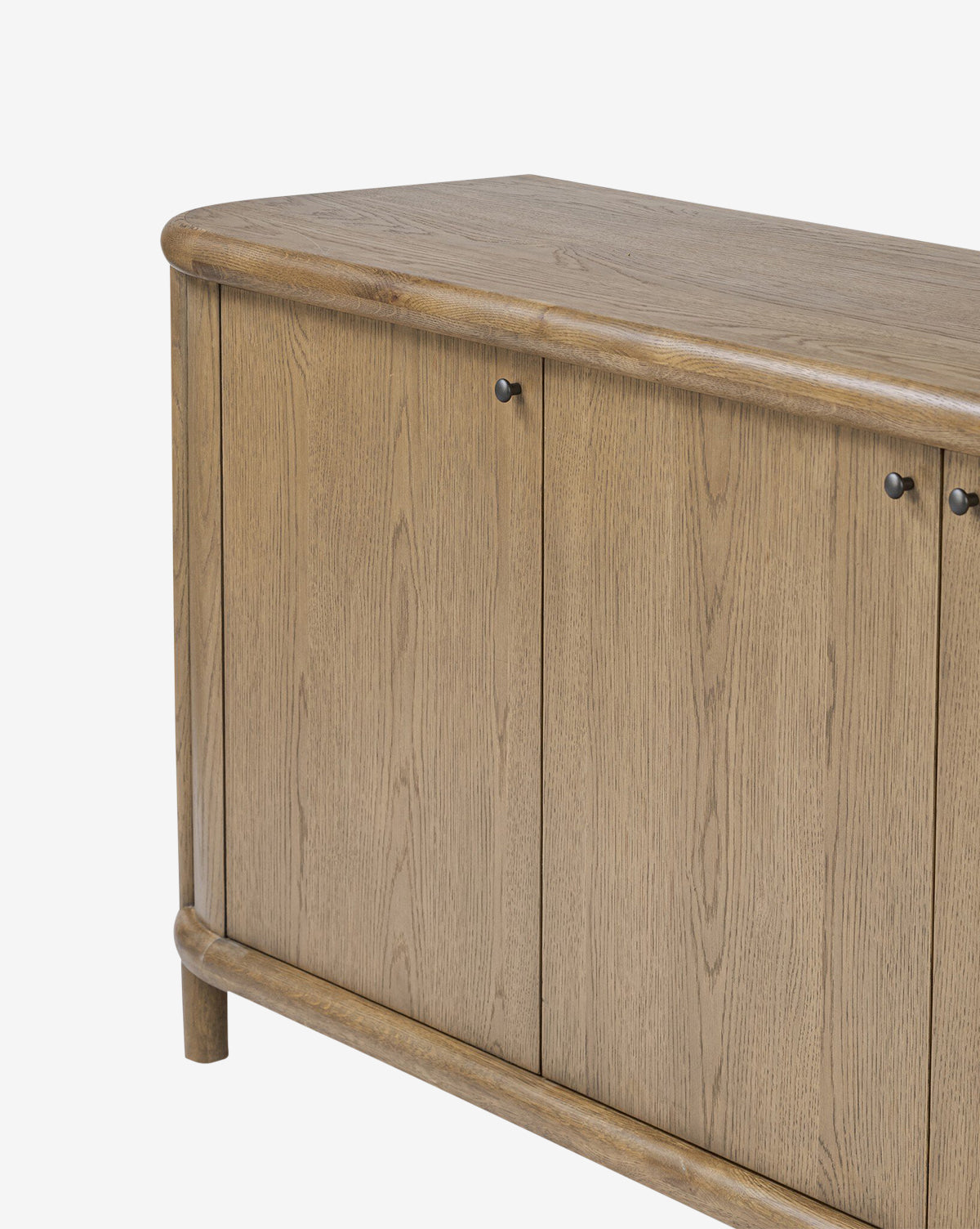 A close-up of the Rolette Sideboard, featuring light brown oak, two doors with rounded edges, and sleek gunmetal pulls, displayed against a white background by McGee & Co.