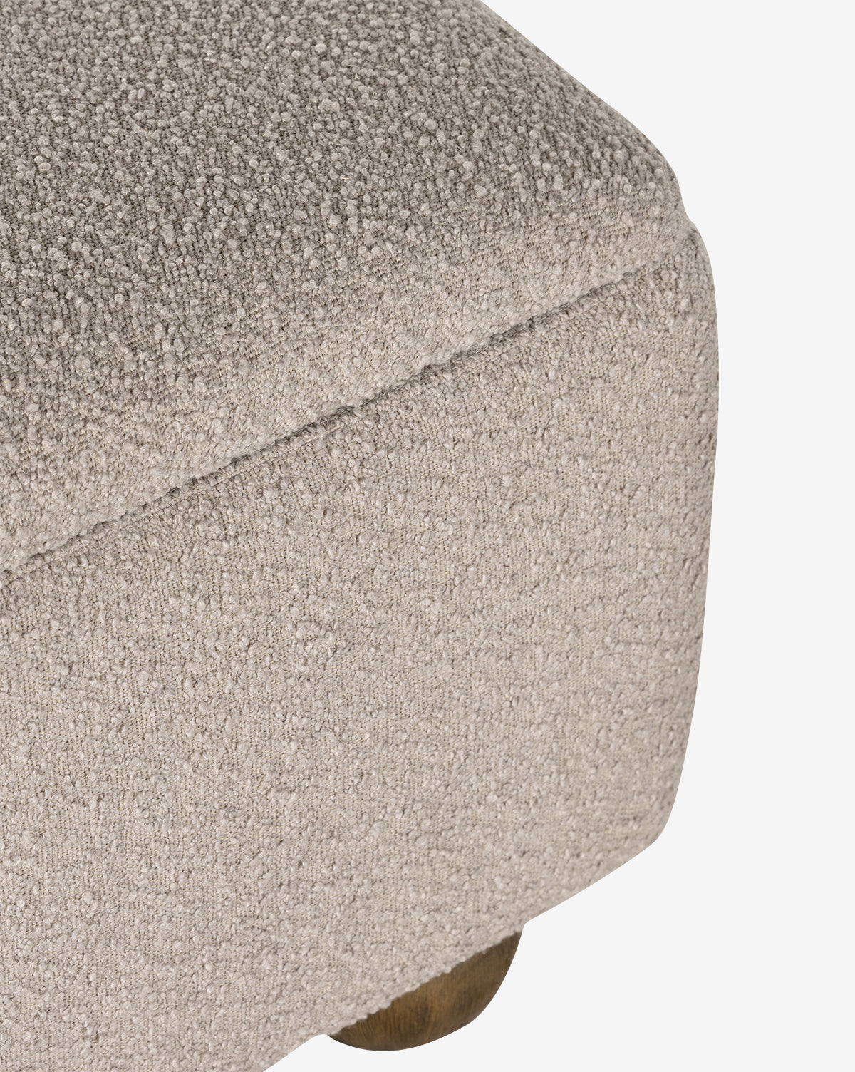 Close-up of the Rowley Trunk in beige textured upholstery with rounded corners and a small wooden leg, highlighting its modern design and performance fabric for lasting style and durability, by McGee & Co.