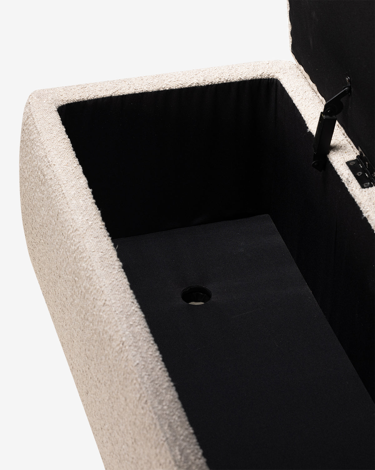 A close-up of the Rowley Trunk shows its open rectangular design with a light performance fabric exterior, black fabric-lined interior, hinged lid, and circular cut-out in the base—perfect for modern design lovers, by McGee & Co.