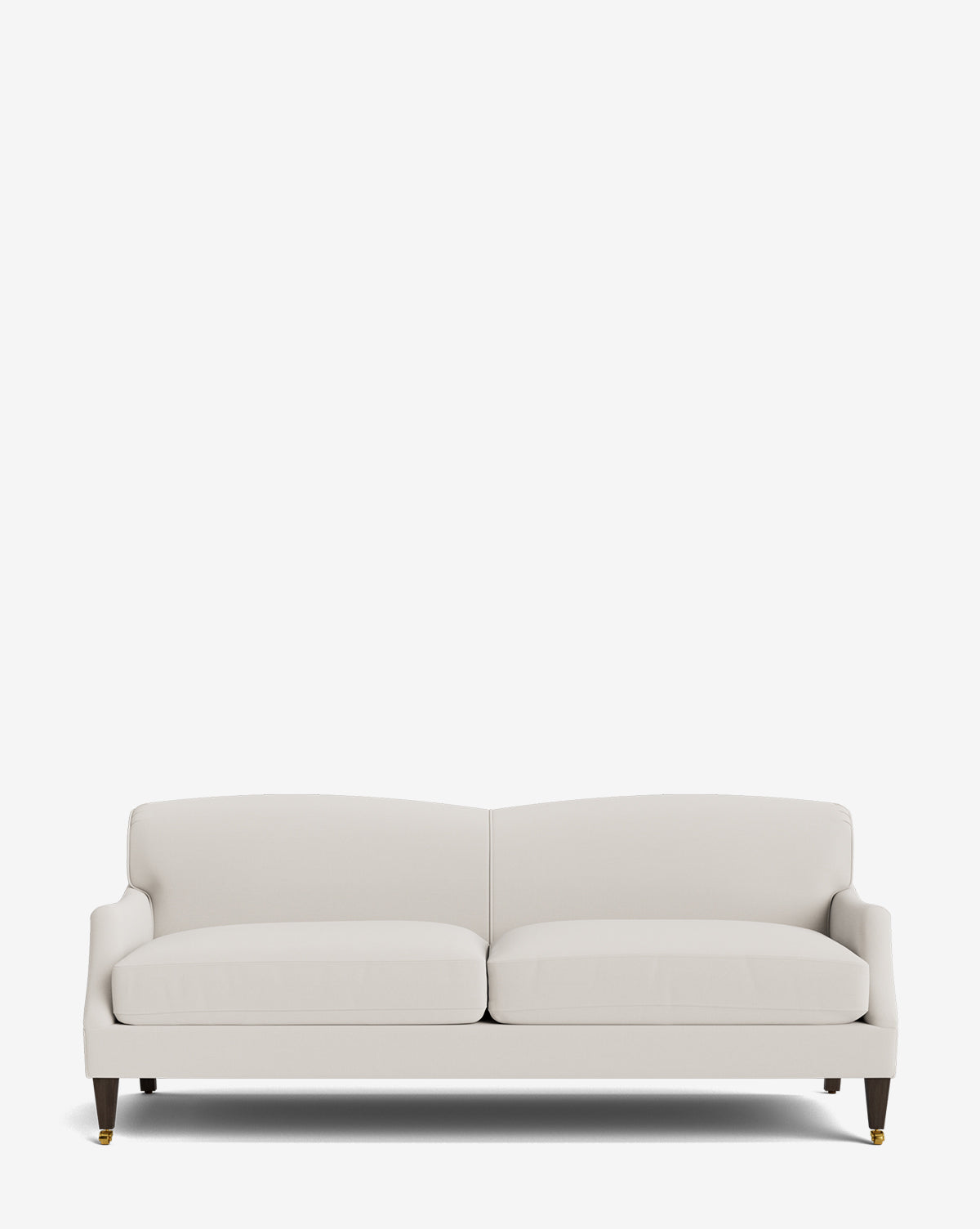 The Rowley Sofa 85 is a modern, light beige sofa with two seat cushions, a low backrest, and short wooden legs with brass castor wheels, hand-crafted and shown against a plain white background by McGee & Co.