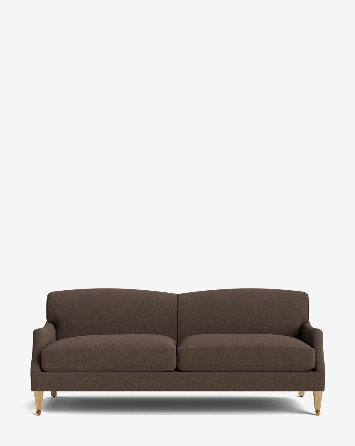 The Rowley Sofa 85 is a modern, hand-crafted dark brown sofa with two seat cushions, a low backrest, and slim wooden legs tipped in gold, shown against a plain white background by McGee & Co.