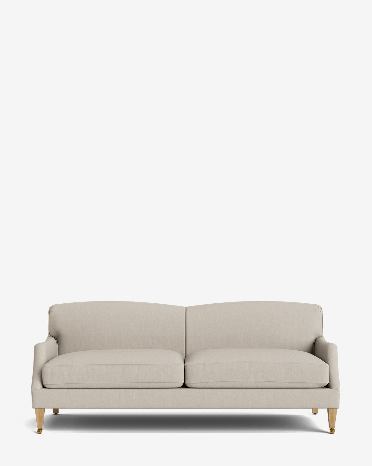 The Rowley Sofa 85 is a modern, hand-crafted three-seat beige sofa with wooden legs and gold casters, shown against a plain white background by McGee & Co.