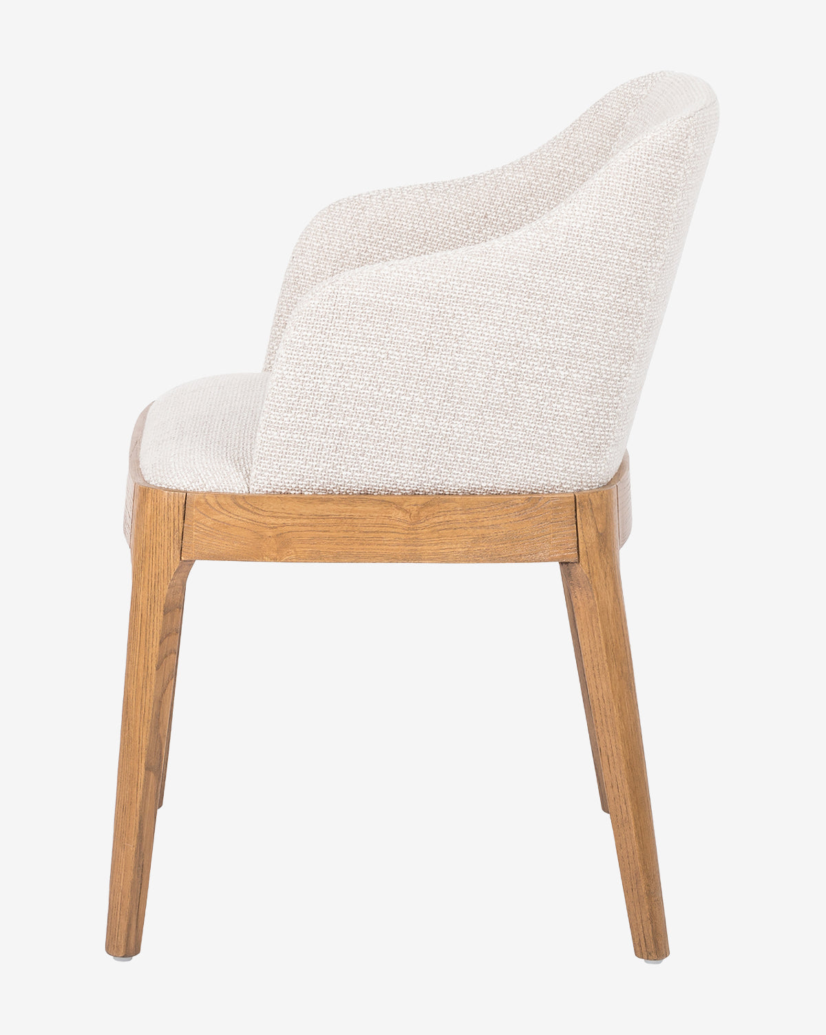 Side view of the Ryne Dining Chair, a modern piece with a cushioned seat and back in light beige fabric, set on solid oak legs and frame, by McGee & Co.