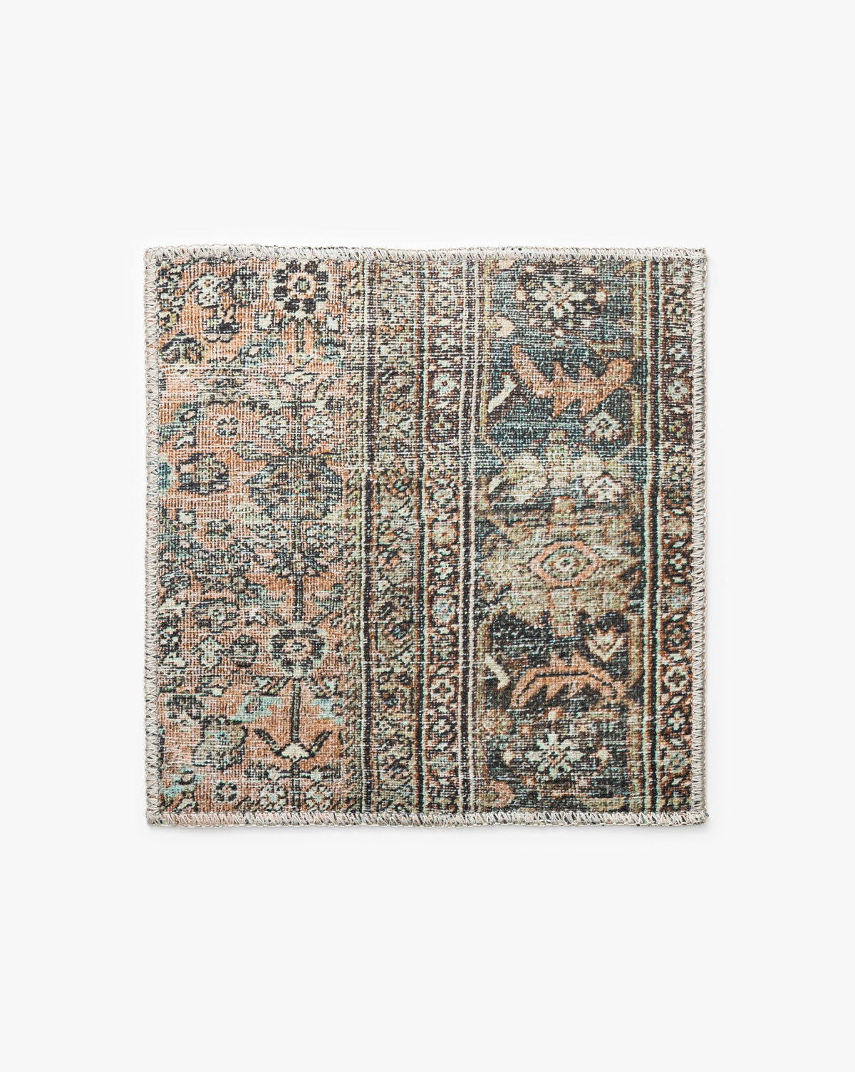 The Santa Maria Rug Swatch is a rectangular, vintage-style sample featuring intricate floral and geometric patterns in muted blue, beige, and brown tones, with a textured feel, fringed border, and charmingly faded appearance, by McGee & Co.