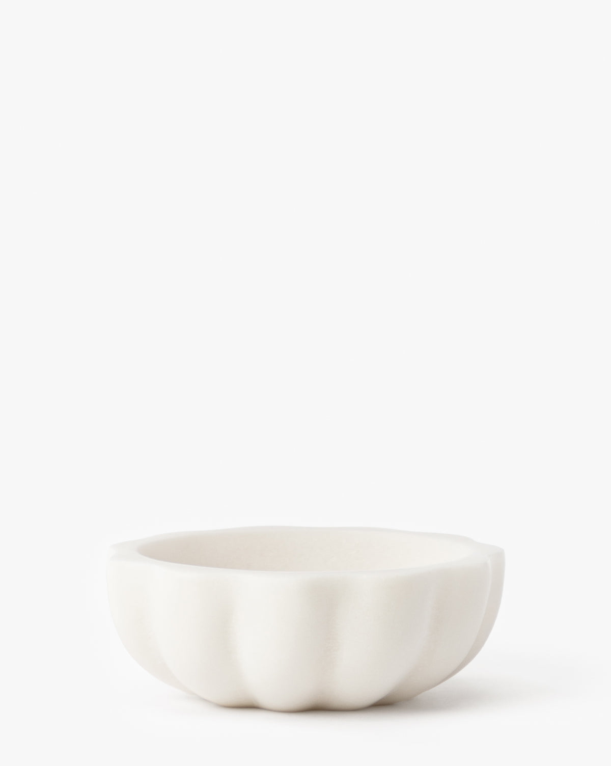 The Scalloped Marble Bowl is a small, white, round bowl with a delicate scalloped edge, displayed against a plain white background by McGee & Co.