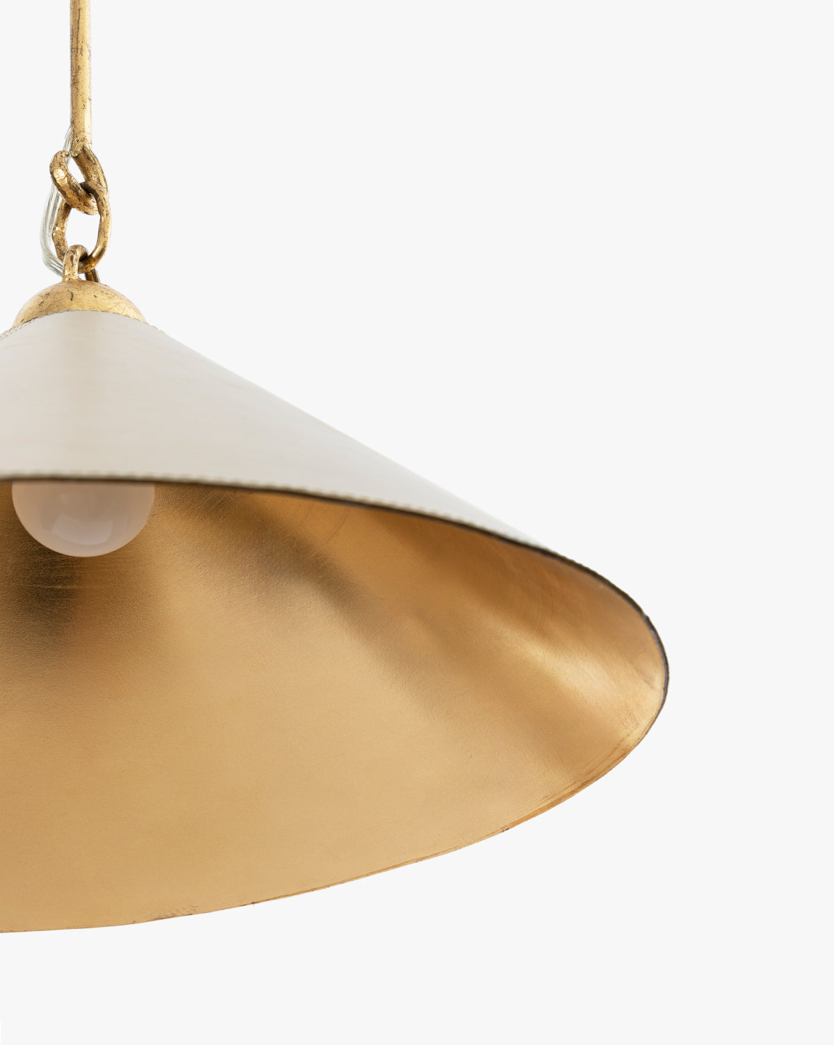 A close-up of the Scarlett Pendant, featuring a gold leafed iron conical shade with a metallic interior, hanging from a chain against a plain white background, by McGee & Co.