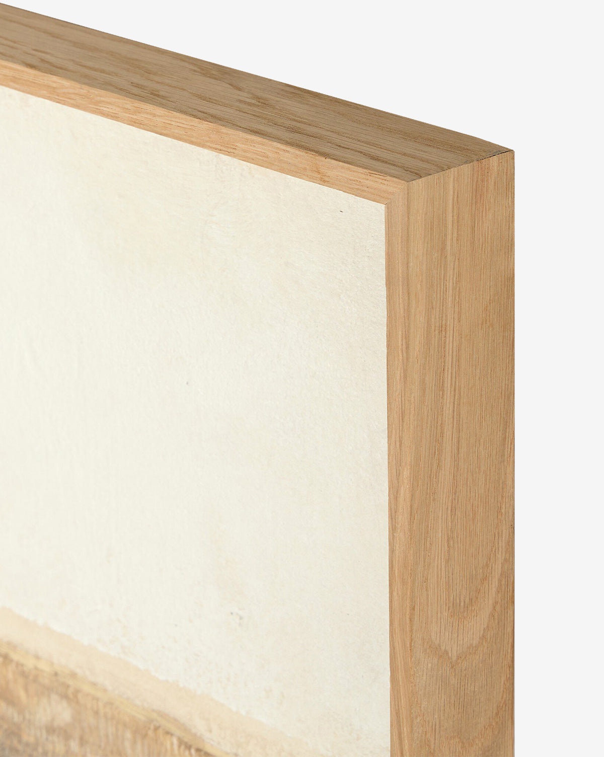 Close-up of the top corner of a white oak frame around Sea Basin by Paul Meyer, a light canvas artwork, against a plain white background—ideal for enhancing your home decor, by McGee & Co.