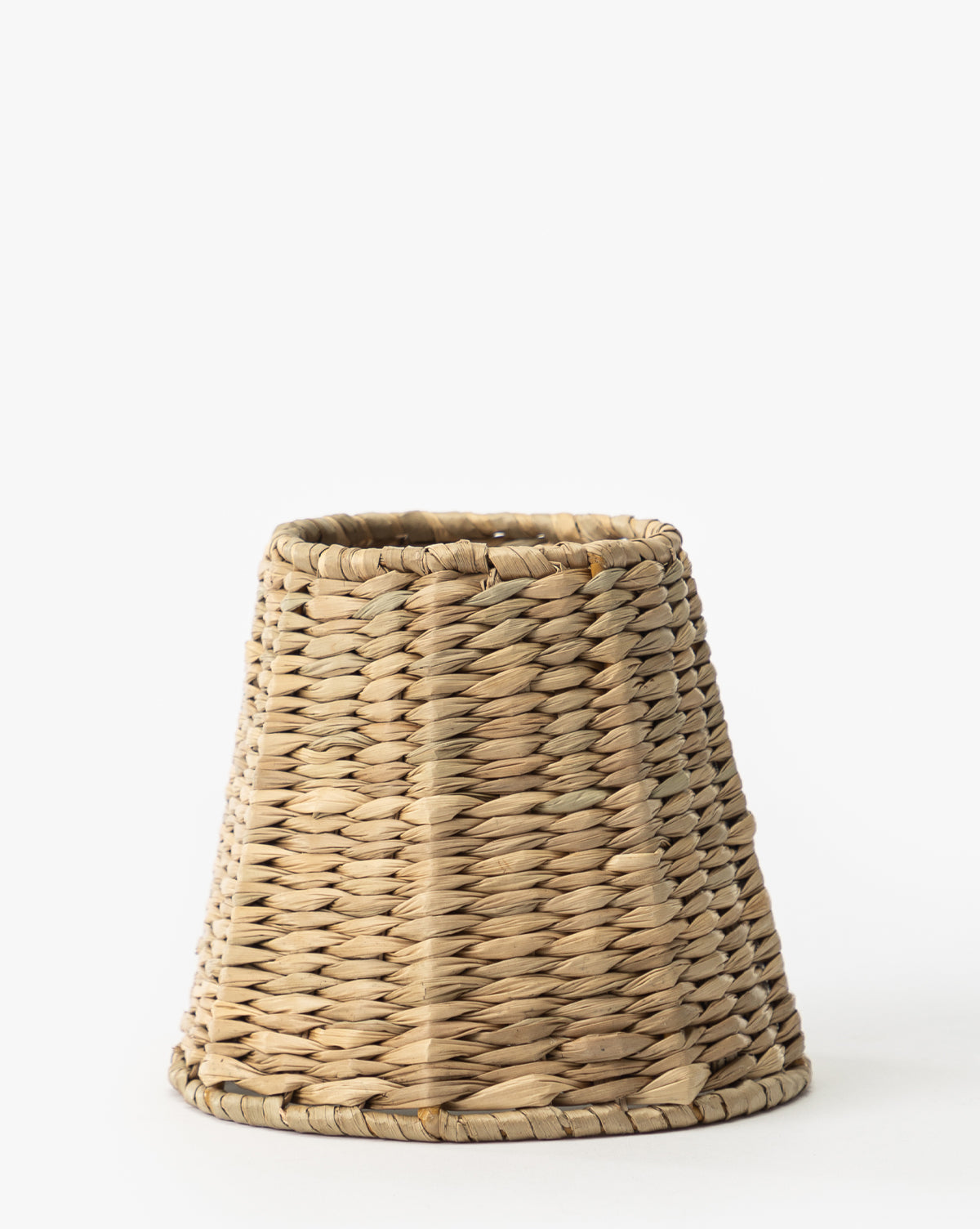 The Zafferano America Seagrass Lamp Shade is a conical, handwoven light brown basket crafted from natural fibers and shown upright against a white background. McGee & Co.