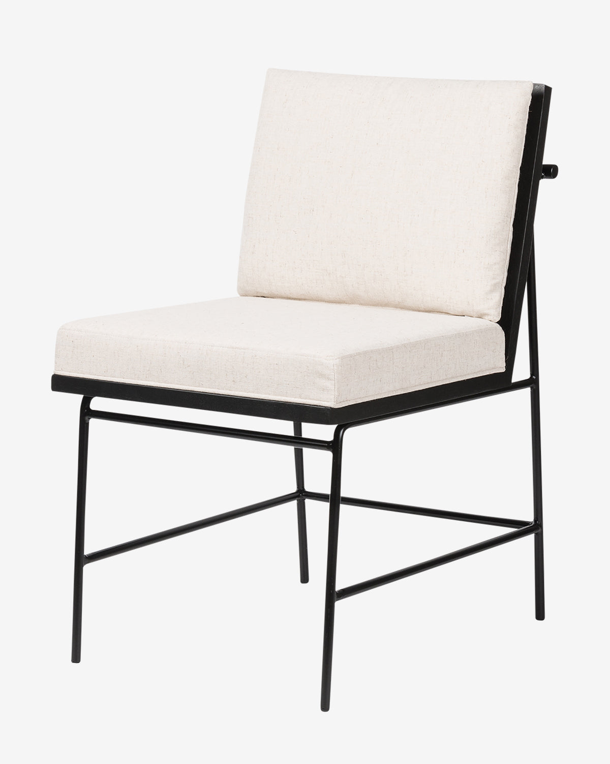 The Selas Dining Chair has a black iron frame with angled legs, plus a cushioned seat and backrest upholstered in off-white high-performance fabric, by McGee & Co.