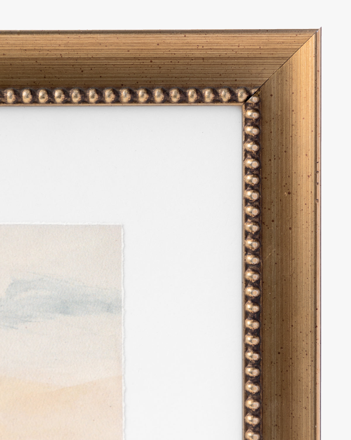 Close-up of the top right corner of a gold frame with decorative beading, bordering the giclee print Sky Studies 1, matted in subtle pastel and neutral tones.