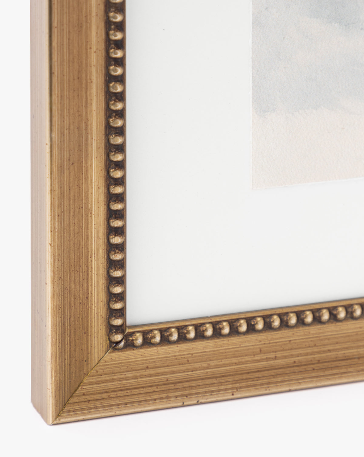 Close-up of the gold-colored frame with decorative inner beading, surrounding the Sky Studies 1 matted giclee print in neutral tones.