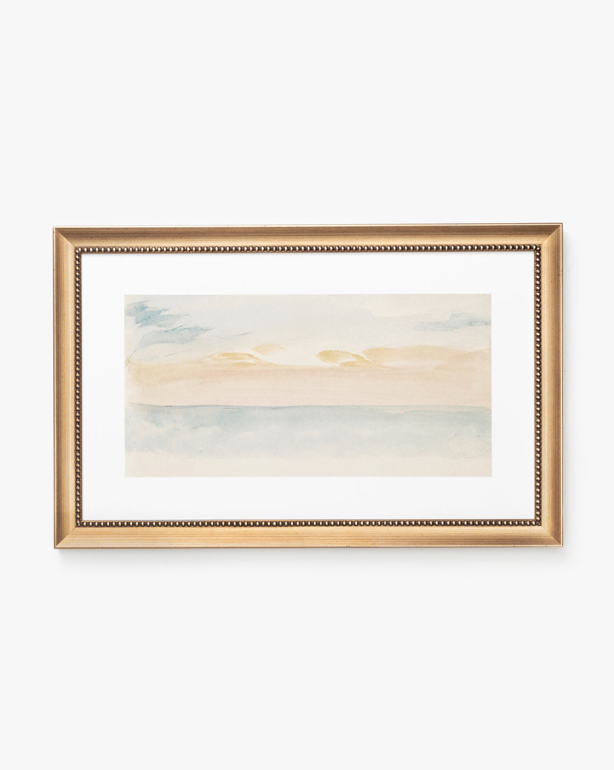 Sky Studies 1 is a framed watercolor painting in soft pastel blue, beige, and peach, depicting a serene abstract landscape with calm sky and water. The gold frame features a beaded inner edge for an elegant finish.