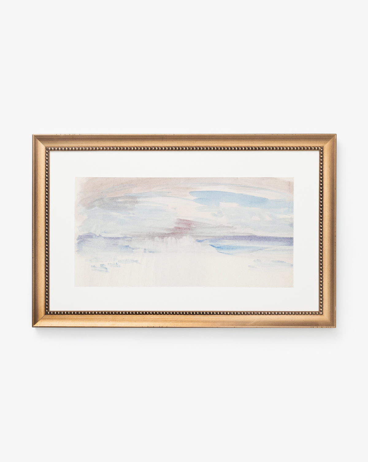 Sky Studies 3 is a framed abstract watercolor painting featuring soft blue, lavender, and beige brushstrokes in a gold beaded frame. This calming artwork has a minimal, serene look.