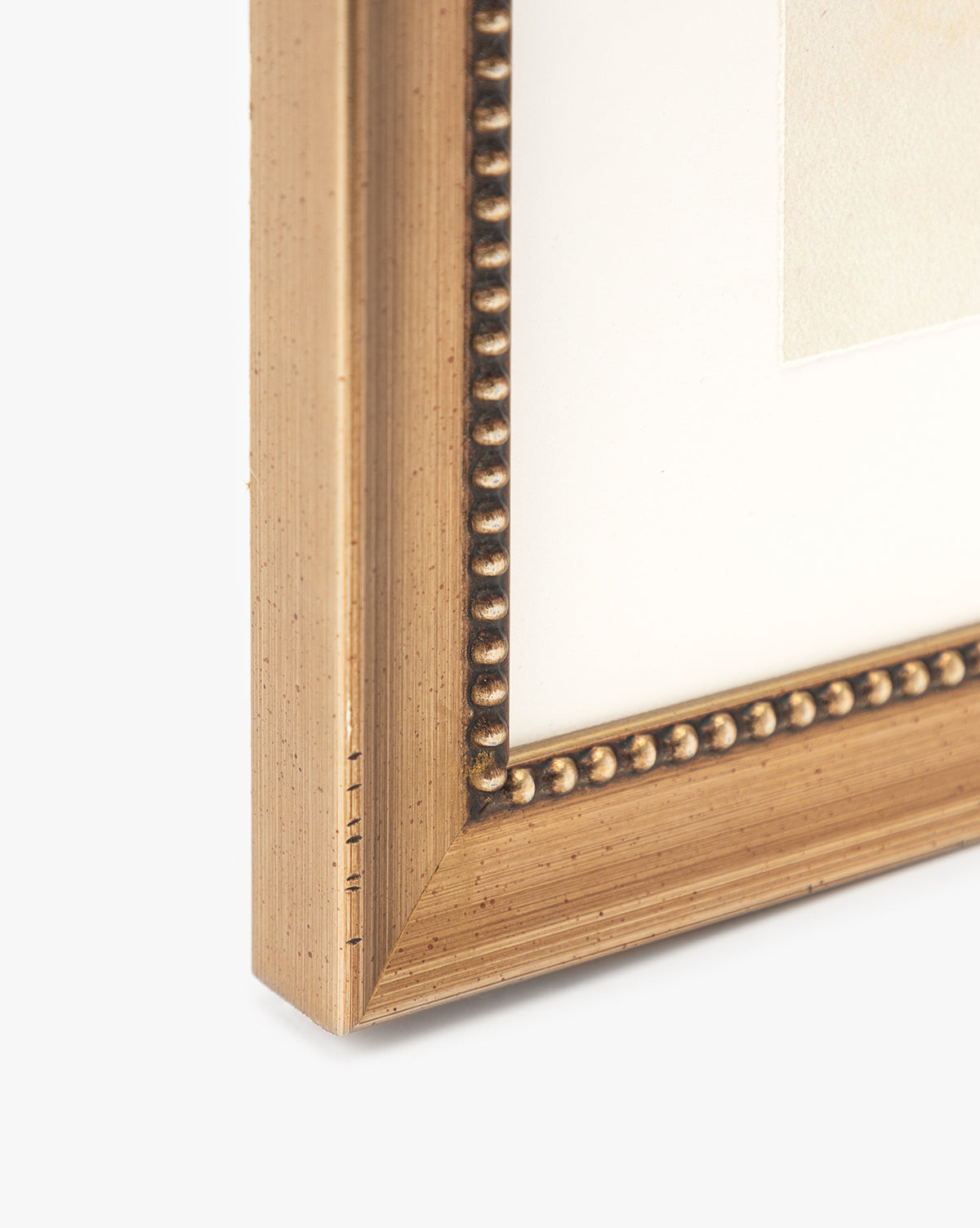 Close-up of the Sky Studies 4 gold-colored picture frame with beaded inner detailing and a white mat, perfect for displaying your giclee print or calming artwork, set against a plain light background.