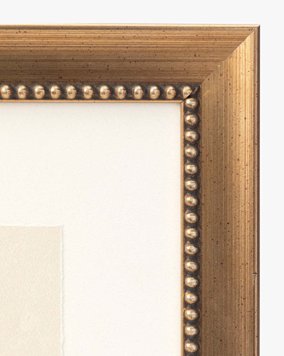 Close-up of the top right corner of an antique silver wood frame with raised beading, featuring a white matte border around the calming artwork Sky Studies 5.
