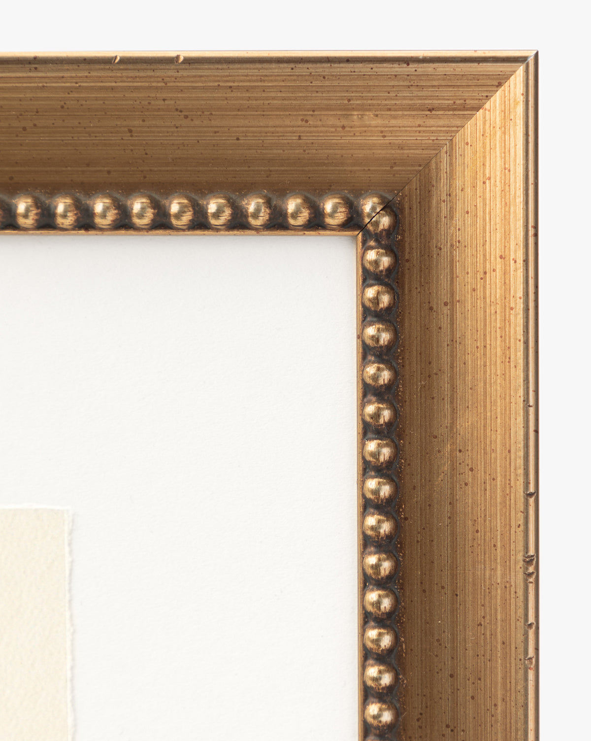 Close-up of the top right corner of an antique silver wood frame with a beaded inner edge and textured surface, showing the white mat and part of Sky Studies 6 giclee print against a white background.