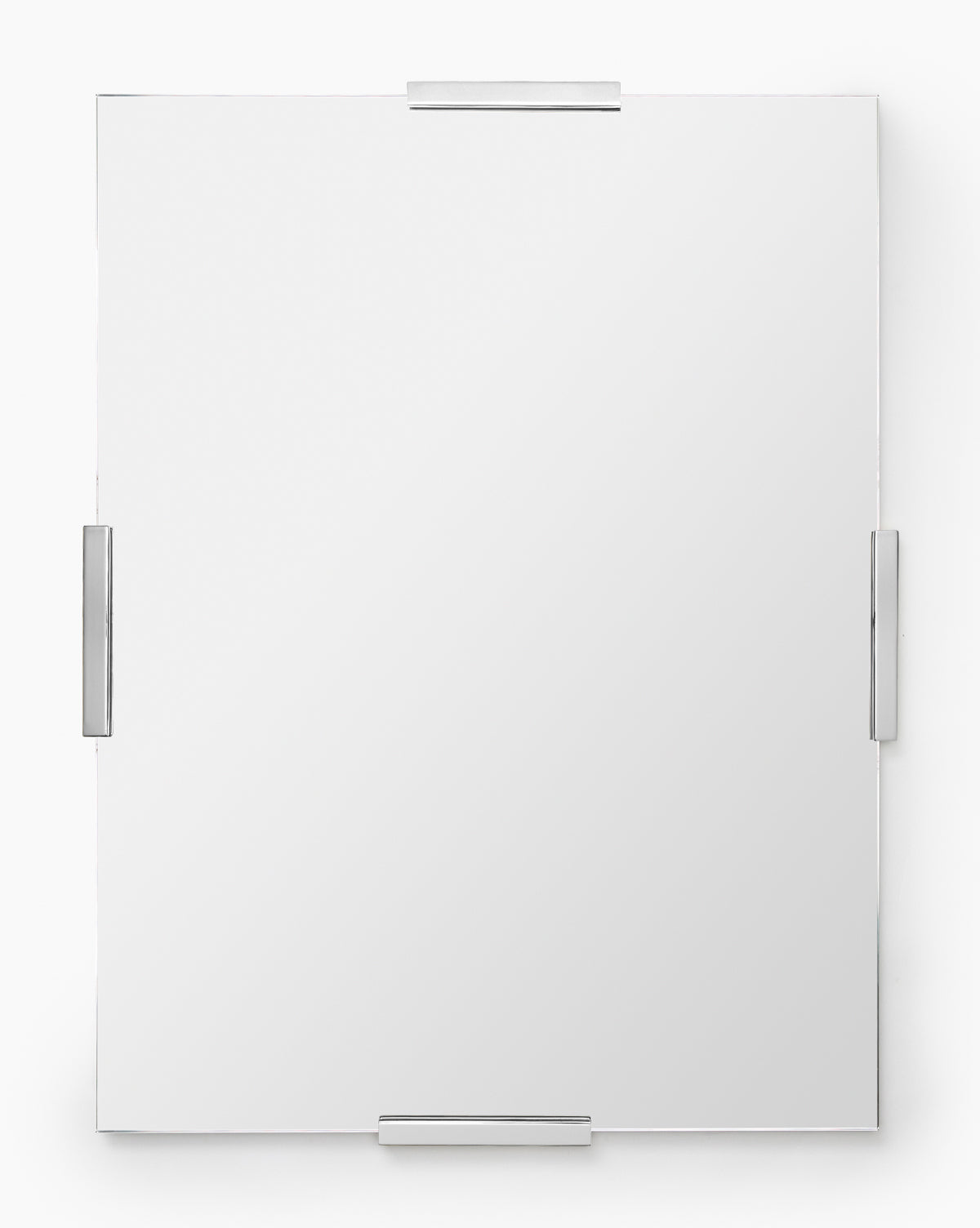 The Slade Mirror is a modern, rectangular frameless mirror secured by four minimalist metal clips—one on each side—for subtle metallic accents against a plain white background, by McGee & Co.