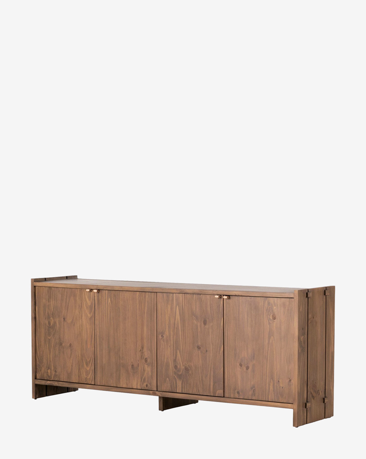 The Sloane Sideboard is a rectangular solid pine piece with four cabinet doors, leather pulls, and a natural wood grain finish, standing on short legs against a plain white background by McGee & Co.