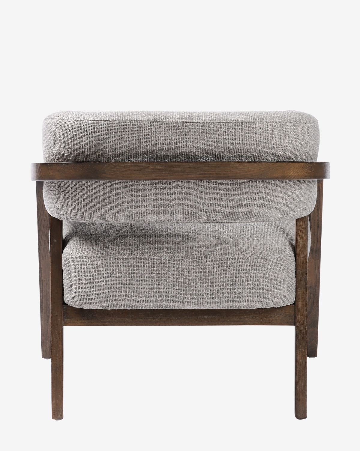 The Stanley Lounge Chair features plush, light gray upholstery with a wooden frame and legs. Seen from the back against a white background, its soft texture and sleek lines showcase a modern, comfortable design by McGee & Co.
