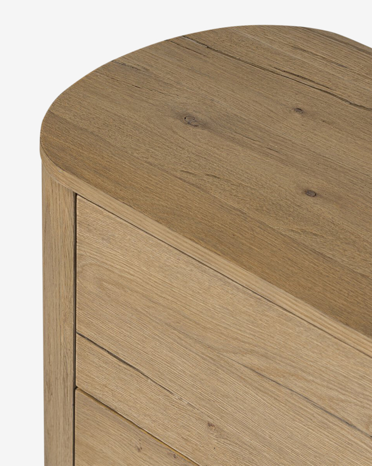 Close-up of the Steffon Nightstand’s top corner, crafted from acacia wood with a smooth, rounded edge and visible wood grain. Photo highlights part of two drawers and the natural texture—perfect for bedroom styling, by McGee & Co.