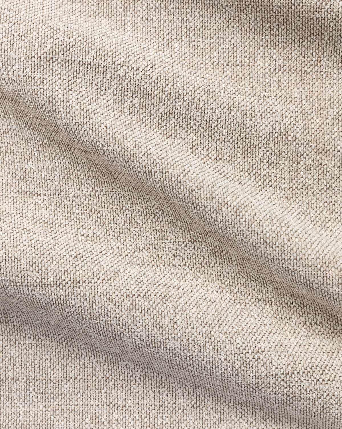 Close-up of Crypton Upholstery Swatch in light beige, showing textured performance fabric with visible weave and gentle horizontal folds that create soft shadows and highlights, by McGee & Co.