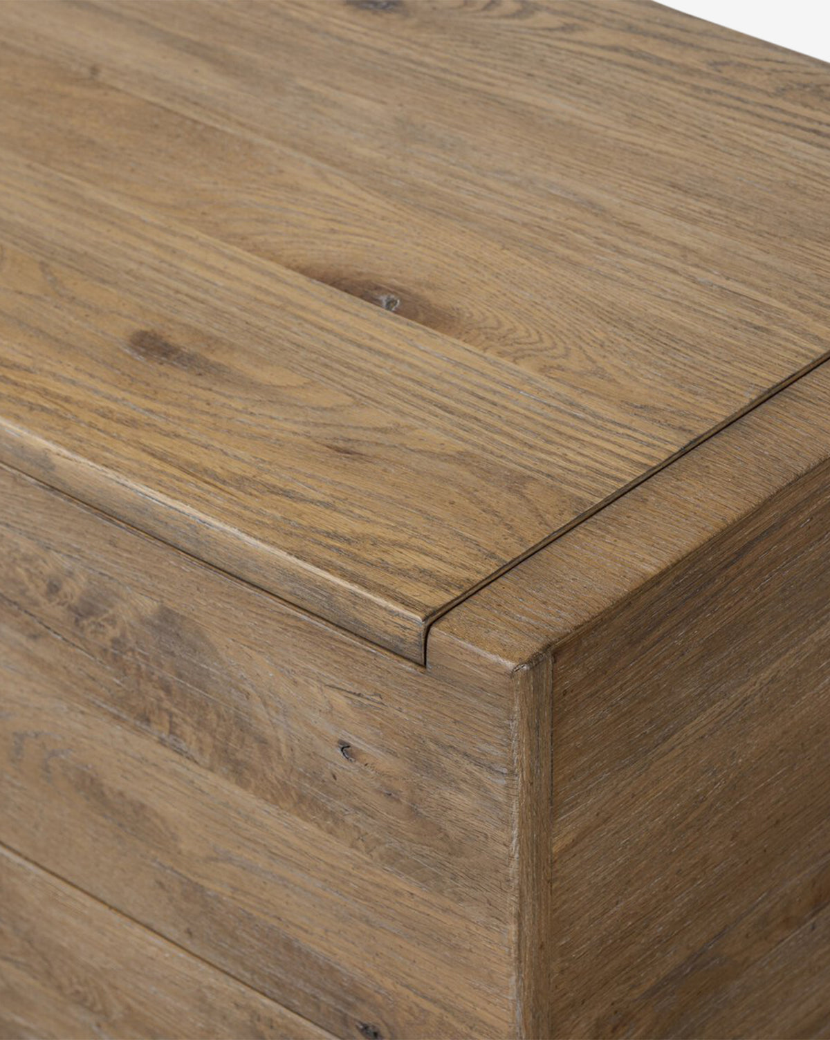 Close-up of a Sutton Trunk, highlighting its natural finish, weathered oak grain, and detailed edge joint—ideal for stylish storage, by McGee & Co.