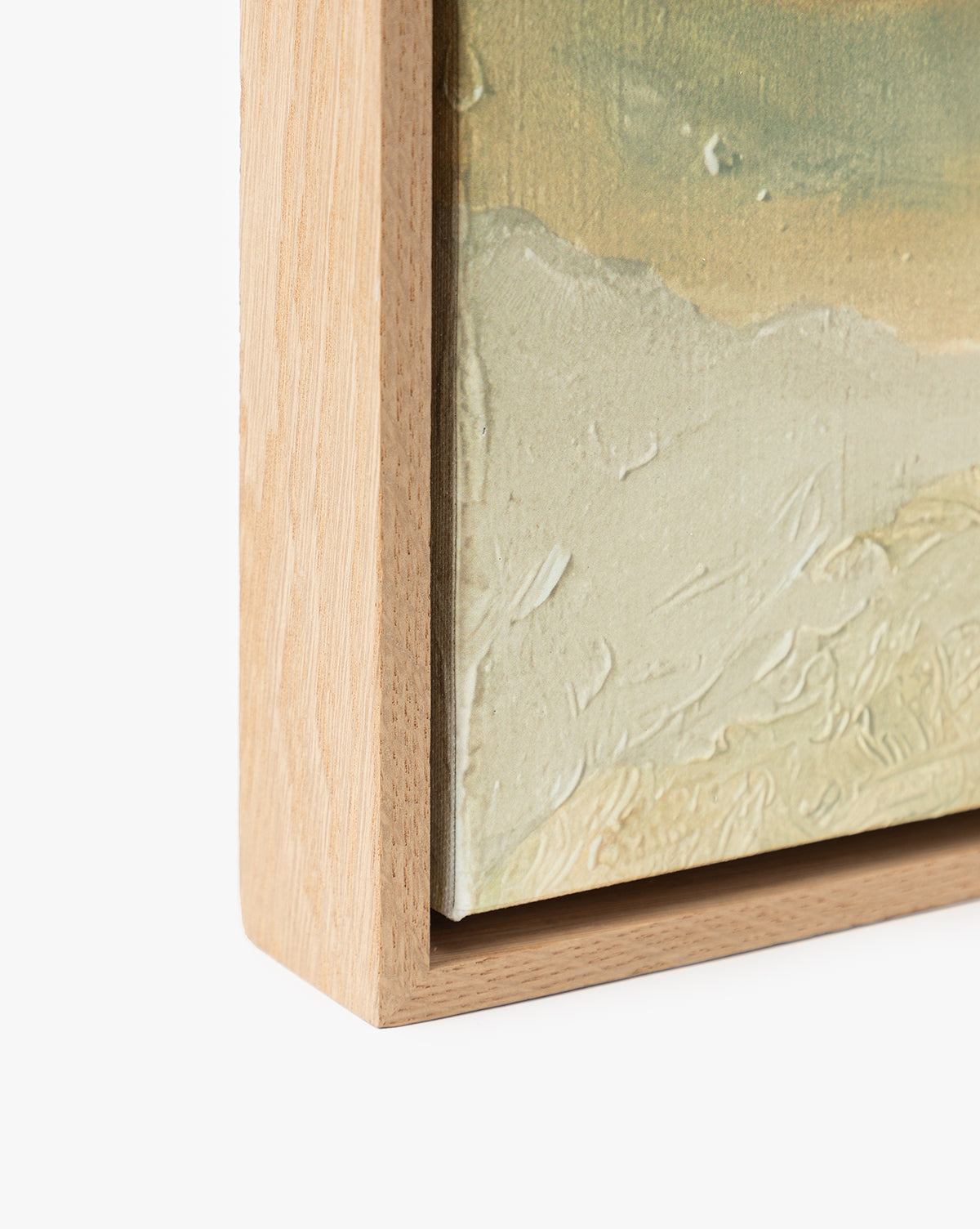 Close-up of “Swallows at Dusk,” a textured skyscape wall art in pale green and beige tones, displayed as a canvas print in a light white oak frame with a gap between the canvas edge and the frame, set against a white background, by McGee & Co.