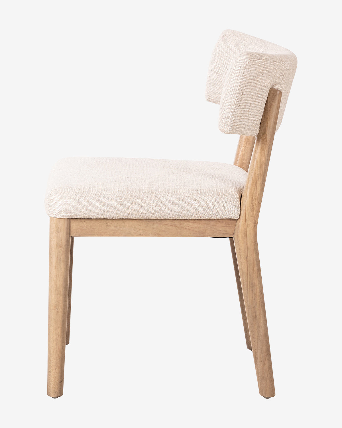 Side view of the Swift Dining Chair with light beige upholstered seat and backrest, showcasing clean lines and a minimalist design against a plain white background, by McGee & Co.