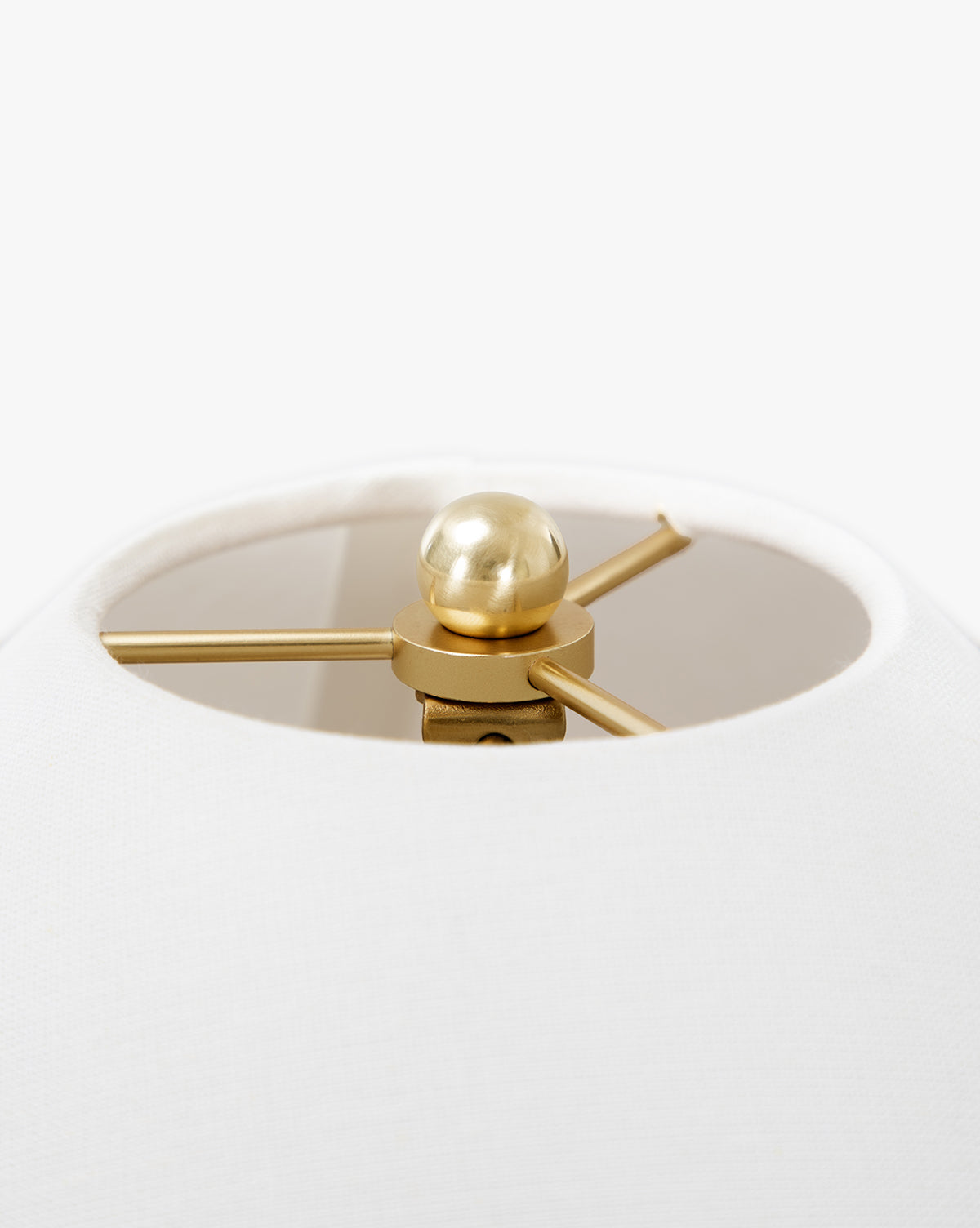 Close-up view of the Townes Floor Lamps white linen shade, highlighting its reeded brass finial and internal metal support structure, by McGee & Co.