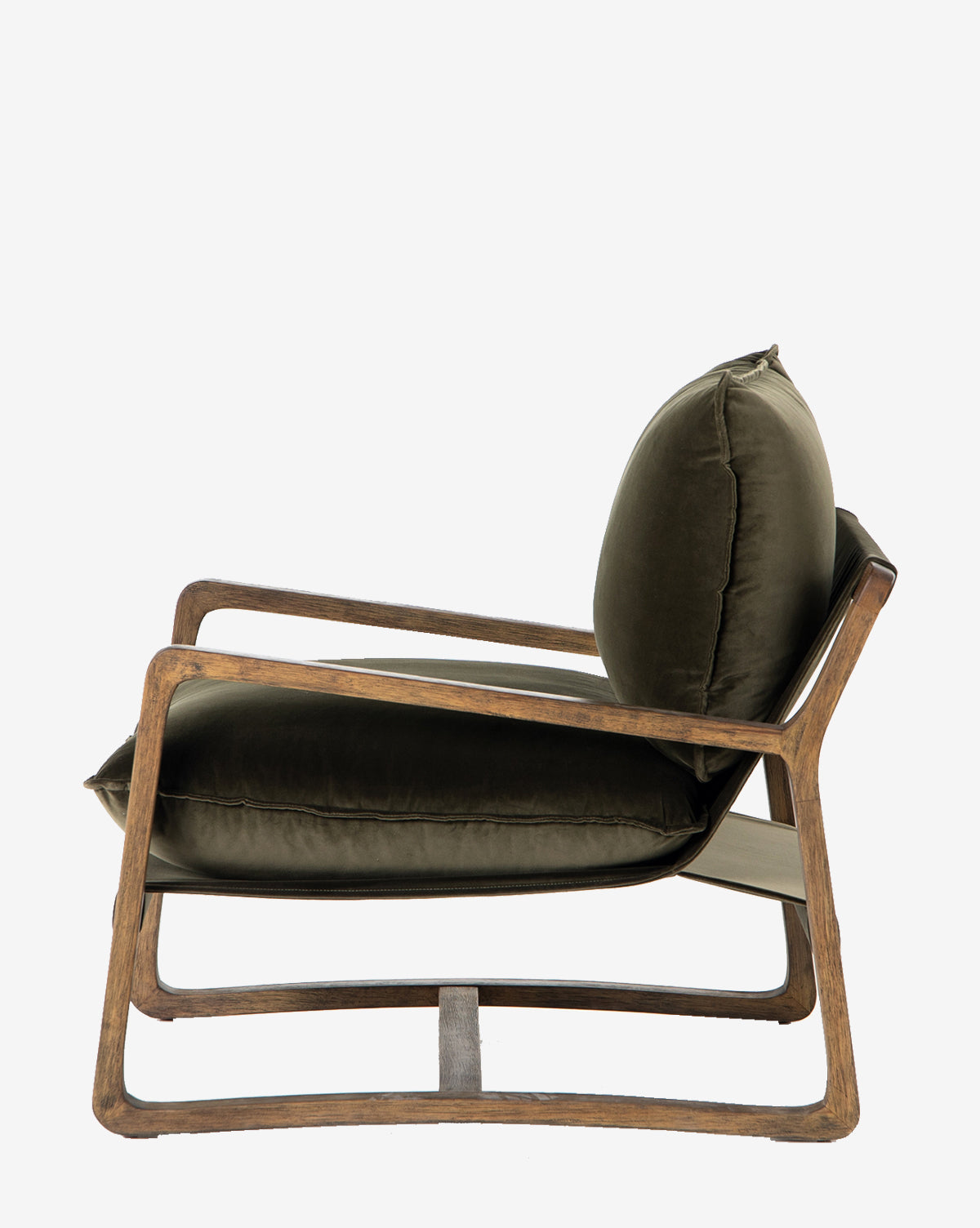 The Ura Lounge Chair has a dark solid ash frame, angled armrests, and plush deep green velvet seat and back cushions, shown from the side against a white background.