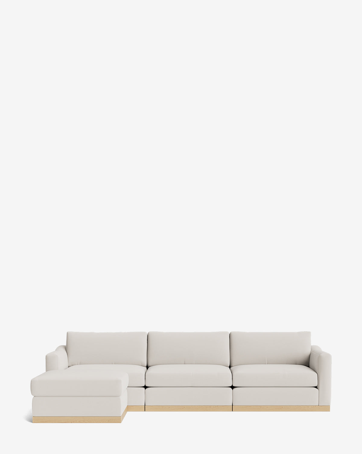 The Vernon Modular Sofa with Ottoman 121 is a modern, light beige sectional featuring a left chaise and low wooden base, by McGee & Co. Its customizable fabric design blends style and comfort, perfect for any contemporary living space.