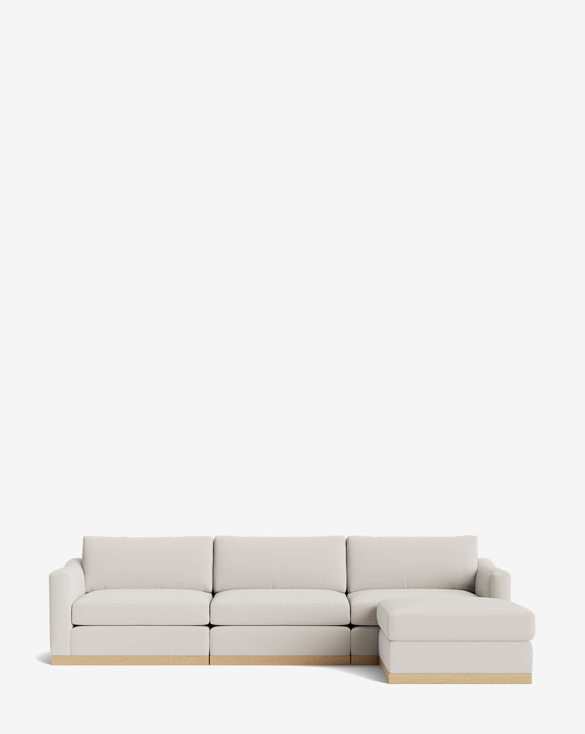 The Vernon Modular Sofa with Ottoman 121 is a modern, light beige fabric sectional featuring three seats, a right chaise lounge, a minimal wooden base, and clean lines—perfect for contemporary spaces, by McGee & Co.
