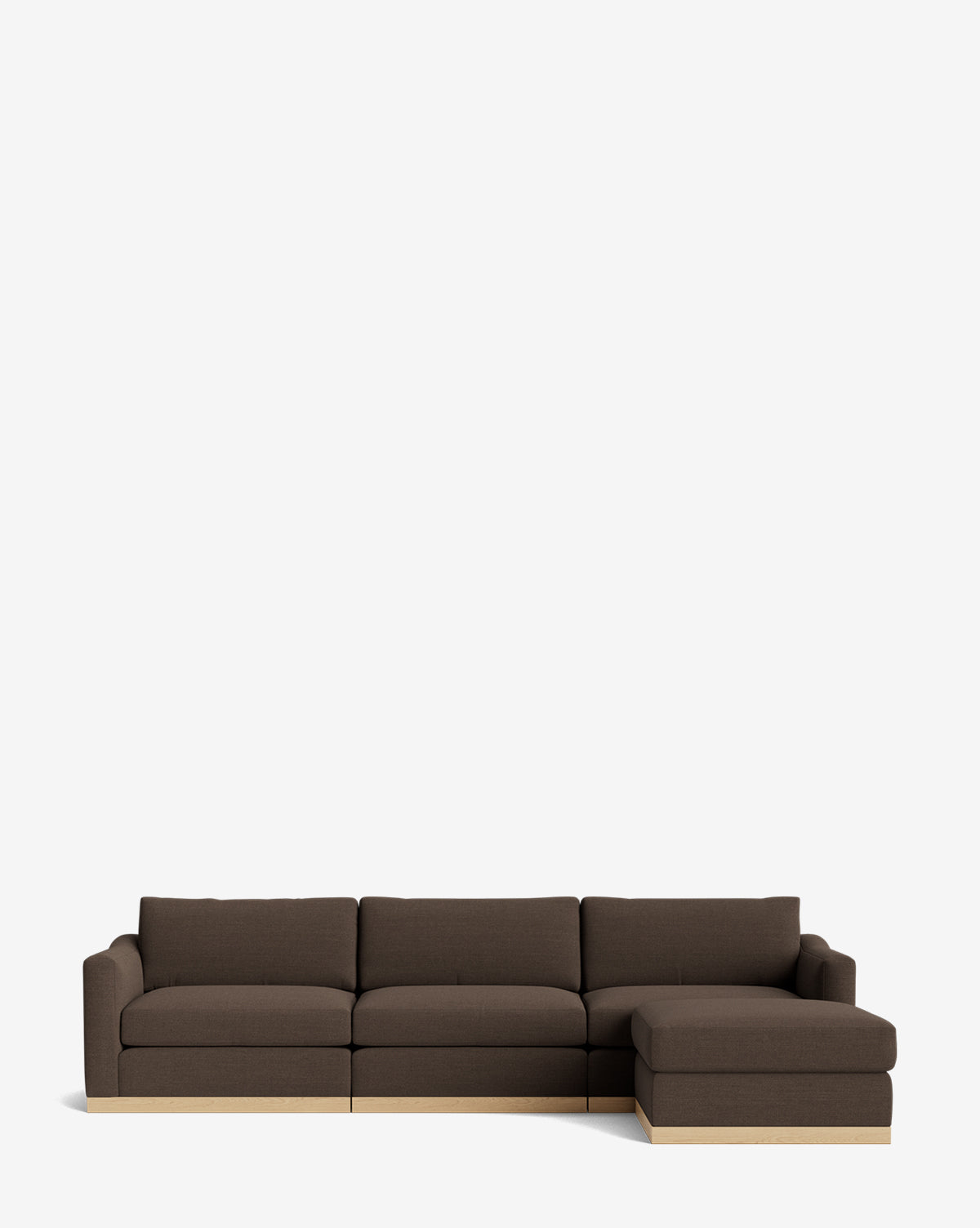 The Vernon Modular Sofa with Ottoman 121 is a dark brown, three-seat sectional with a right-side chaise and light wooden base, set against a white background. This customizable fabric sofa brings modern style and comfort to any living space, by McGee & Co.