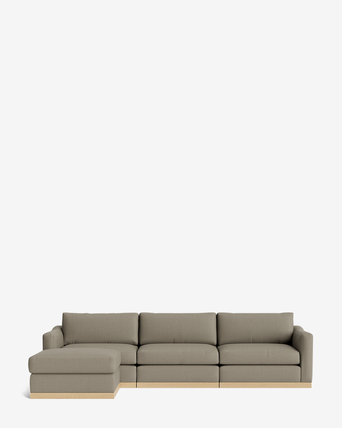 The Vernon Modular Sofa with Ottoman 121 is a modern light gray sectional with three seat cushions, a left-facing chaise lounge, and a light wood base, set against a plain white background by McGee & Co.