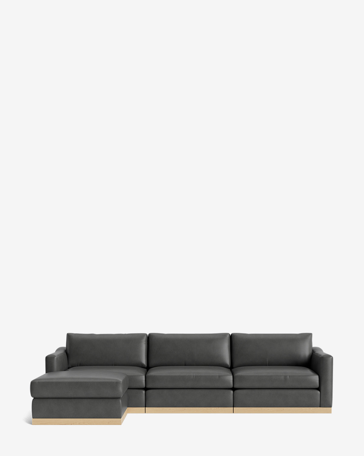 The Vernon Modular Sofa with Ottoman 121 is a modern dark gray sectional with a left chaise, flat cushions, and a low wooden base, shown on a white background—ideal as a customizable fabric sofa for contemporary interiors, by McGee & Co.