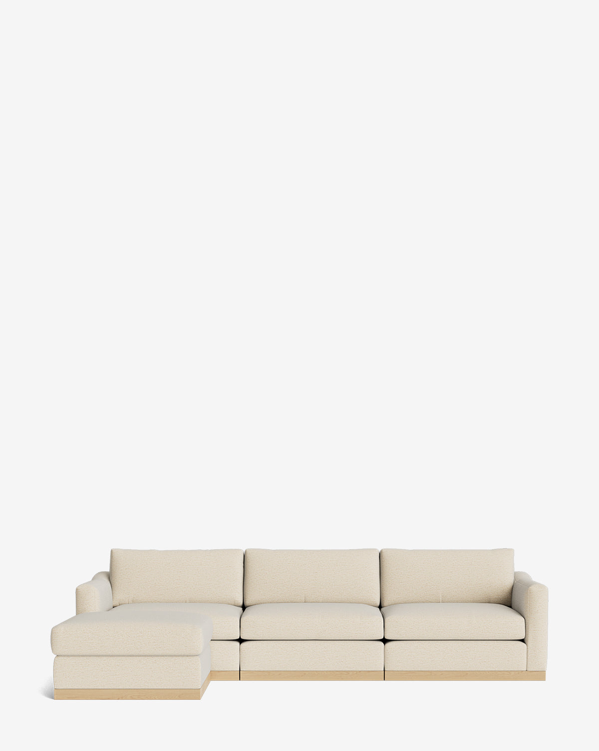 The Vernon Modular Sofa with Ottoman 121 is a modern beige sectional featuring customizable fabric, a left-side chaise lounge, low wooden base, three seat cushions, and an ottoman—all shown against a white background, by McGee & Co.