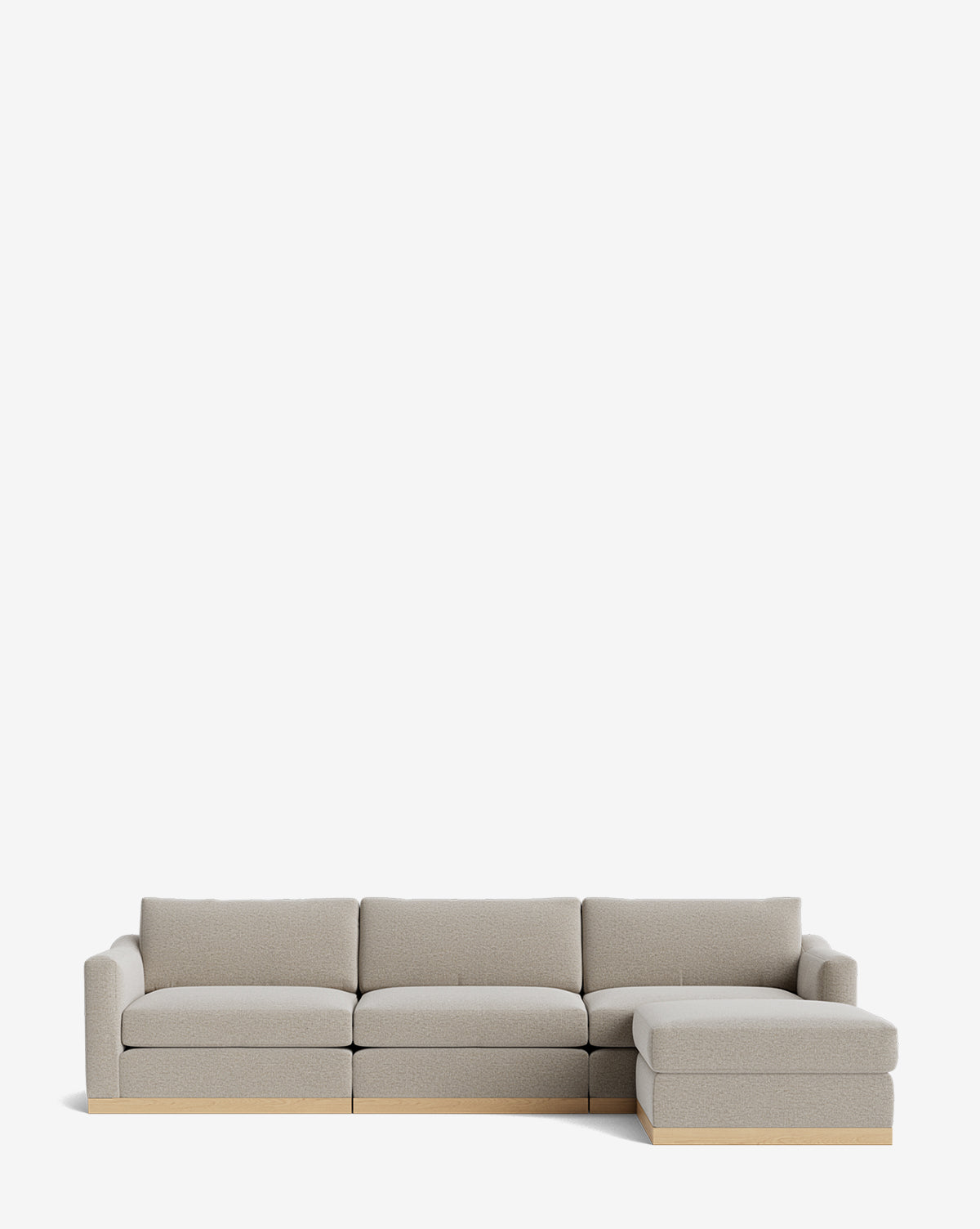 The Vernon Modular Sofa with Ottoman 121 is a modern light gray fabric sofa with four seats, a right-side chaise lounge, low wooden base, plush cushions, and customizable options, by McGee & Co. Shown against a plain white background.