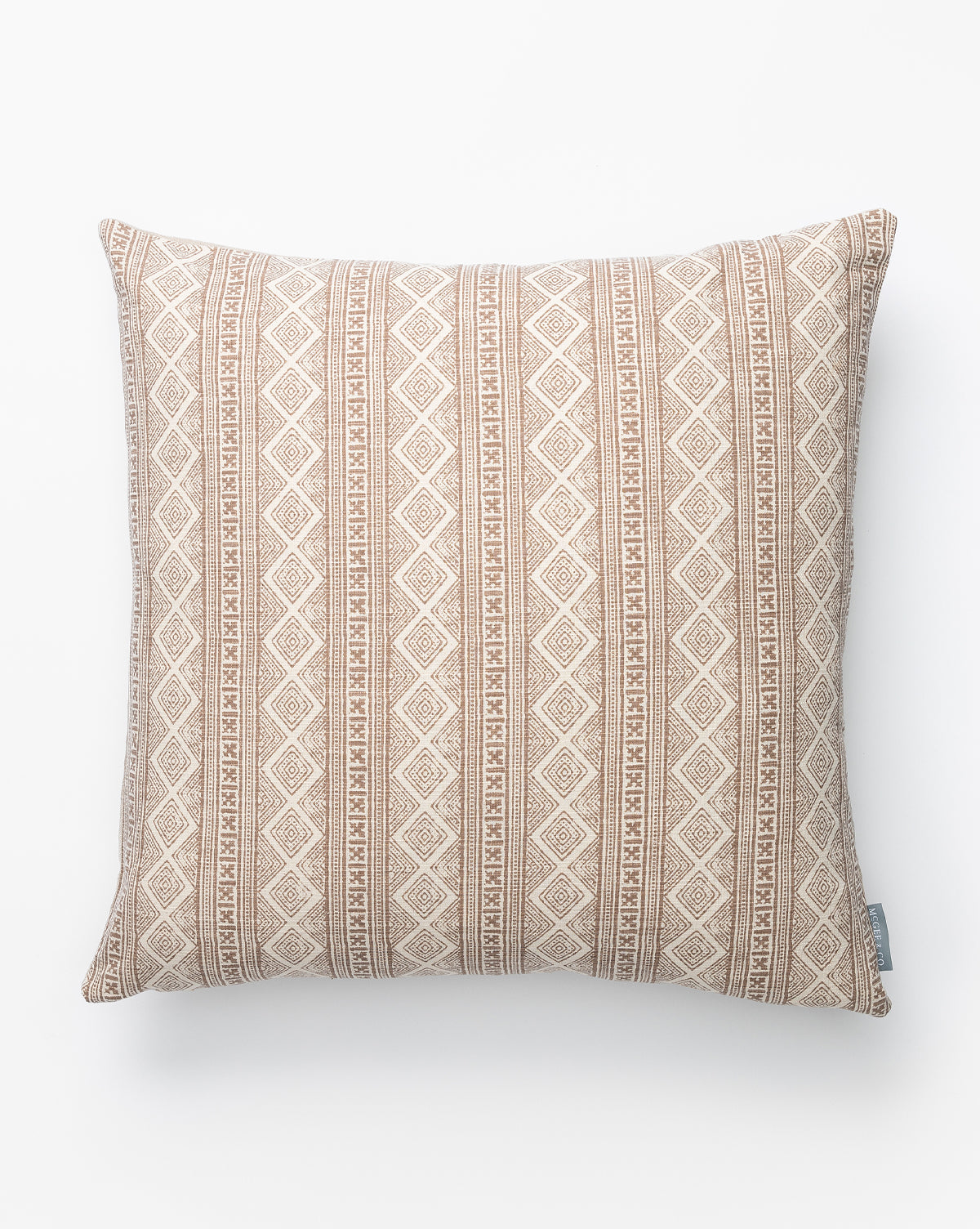 Vintage Tribal Patterned Pillow Cover No. 3 in beige features a diamond and vertical line design in white and light brown, set against a plain white background with a small fabric tag on the side, by McGee & Co.