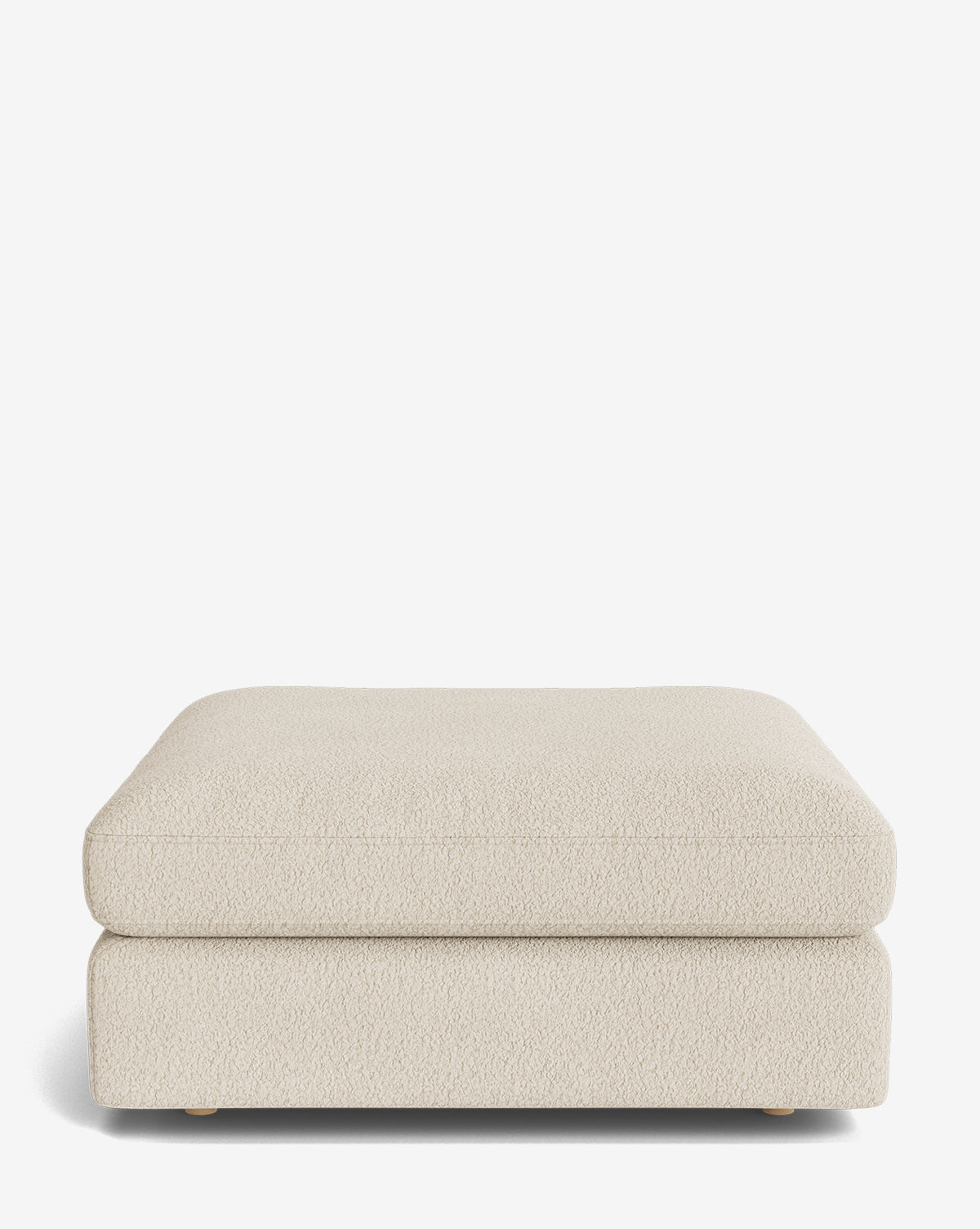 The Vivienne Modular Ottoman is a rectangular, cream-colored piece with textured fabric and low wooden feet, shown against a plain white background by McGee & Co.