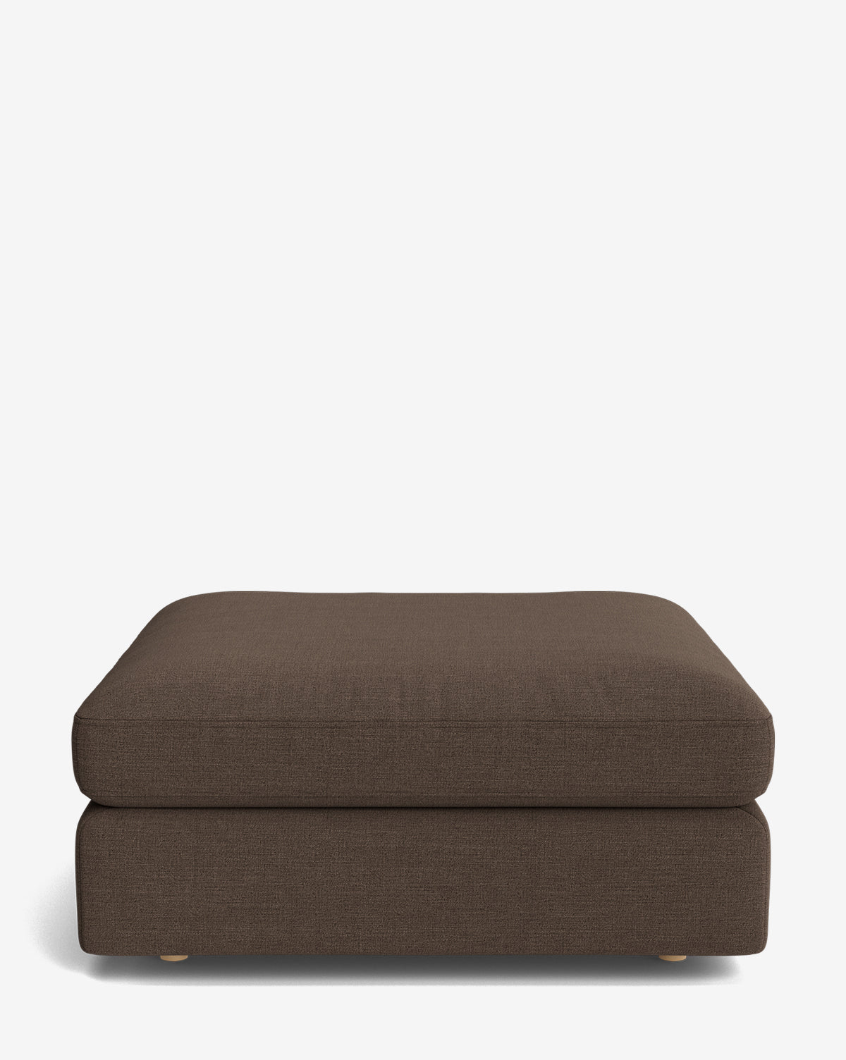 The Vivienne Modular Ottoman features a rectangular, dark brown upholstered design with a plush cushion and small, round wooden feet, shown on a plain white background by McGee & Co.