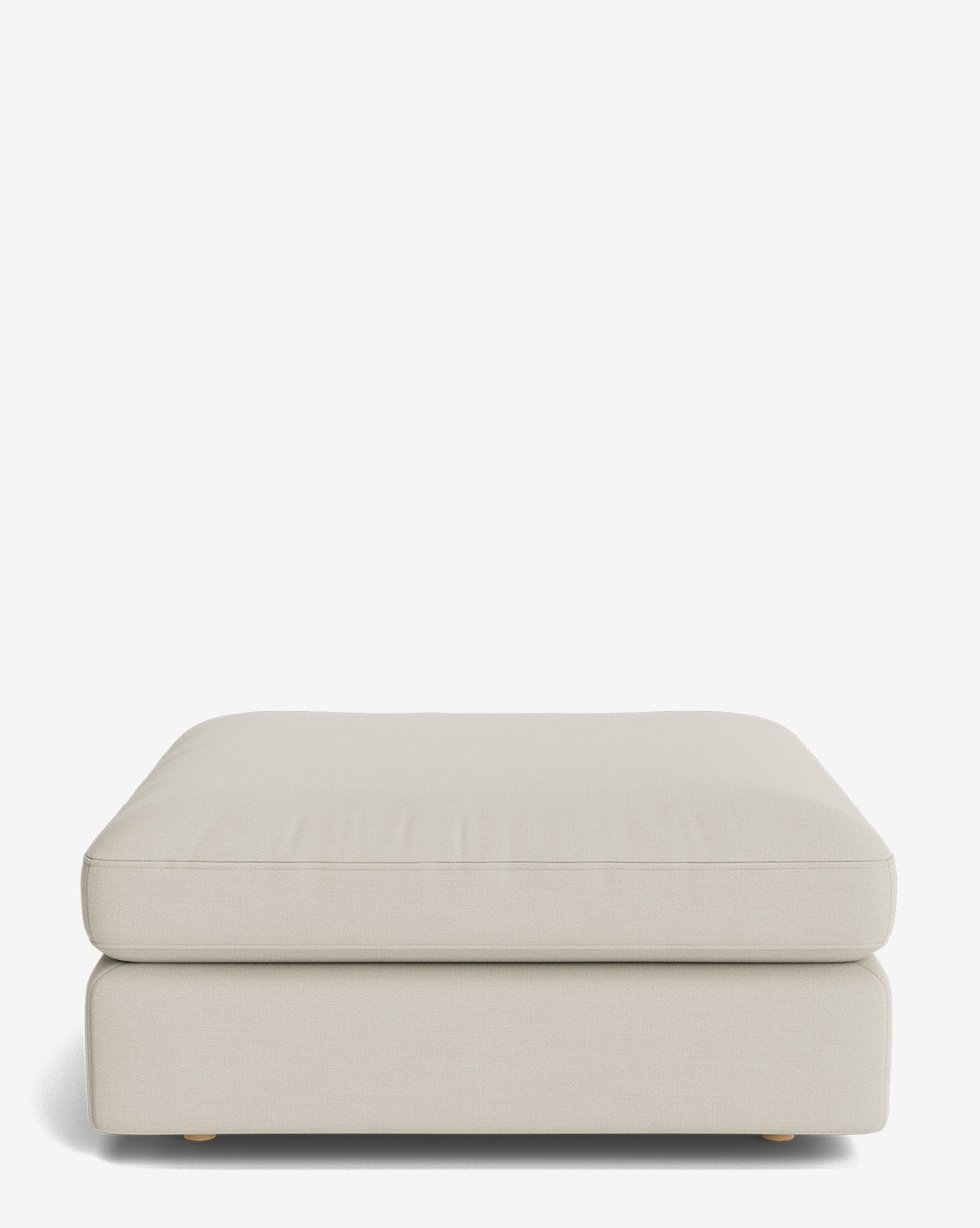 The Vivienne Modular Ottoman is a large, rectangular piece featuring light beige smooth upholstery and a minimalistic design, shown against a plain white background, by McGee & Co.