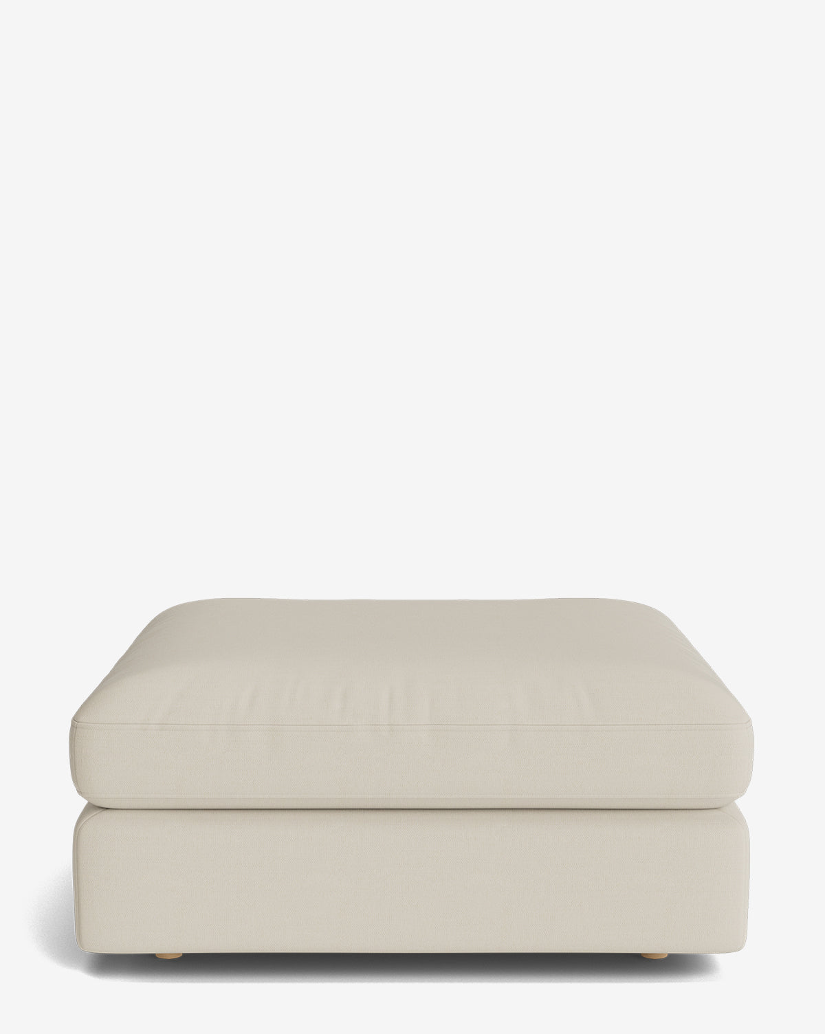 The Vivienne Modular Ottoman is a large, rectangular beige piece with a soft cushioned top and low profile, showcased against a plain white background by McGee & Co.