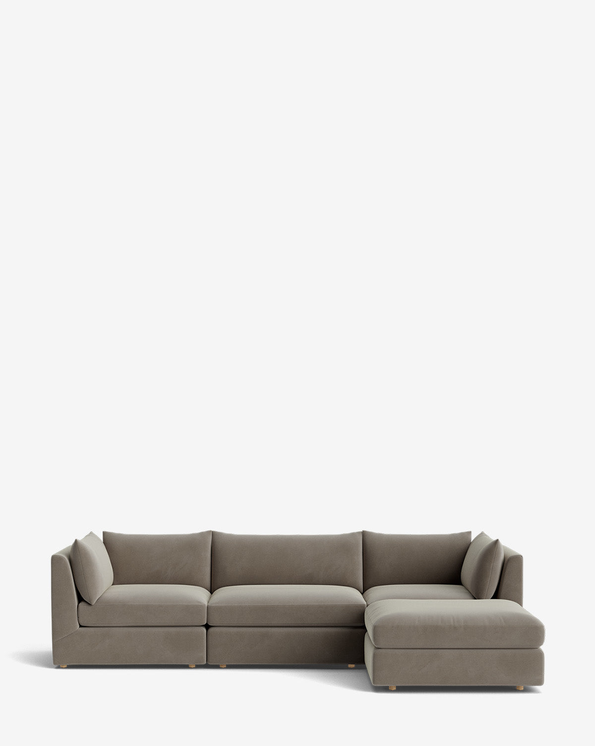 The Vivienne Modular Sofa with Ottoman is a modern, L-shaped gray fabric sofa with three seat cushions, low backrests, and a right-facing chaise lounge, shown against a plain white background by McGee & Co.