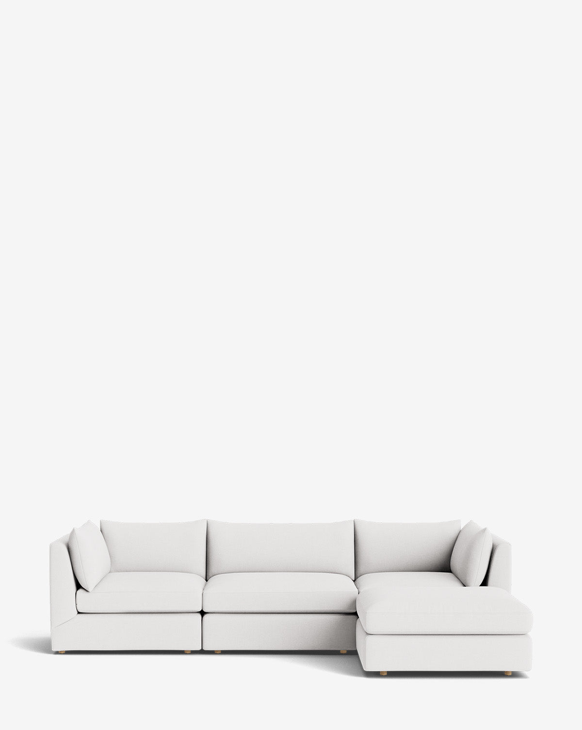 The Vivienne Modular Sofa with Ottoman is a light gray three-seater with a right-side chaise lounge, featuring clean lines and a minimalistic design, shown against a plain white background by McGee & Co.