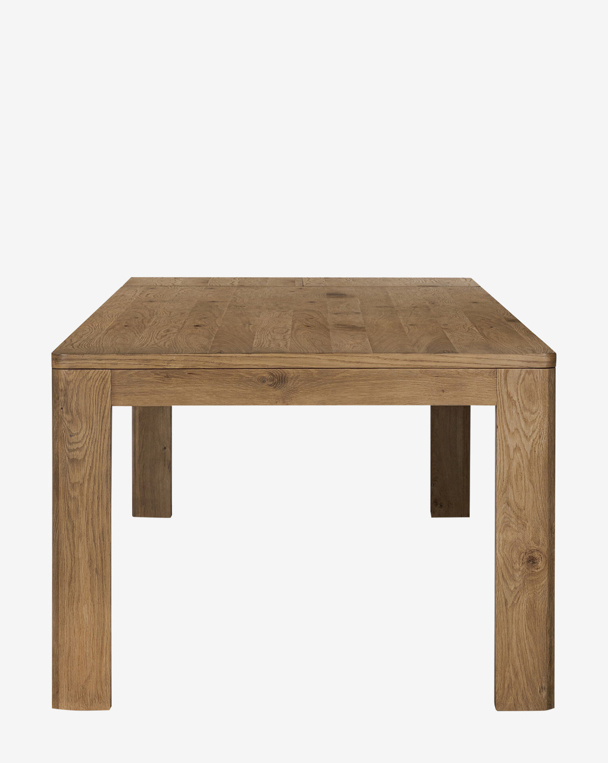The Wagner Extension Dining Table is a square oak table with a natural finish, shown from the end against a plain white background. It features sturdy construction, thick legs, and a smooth flat surface by McGee & Co.