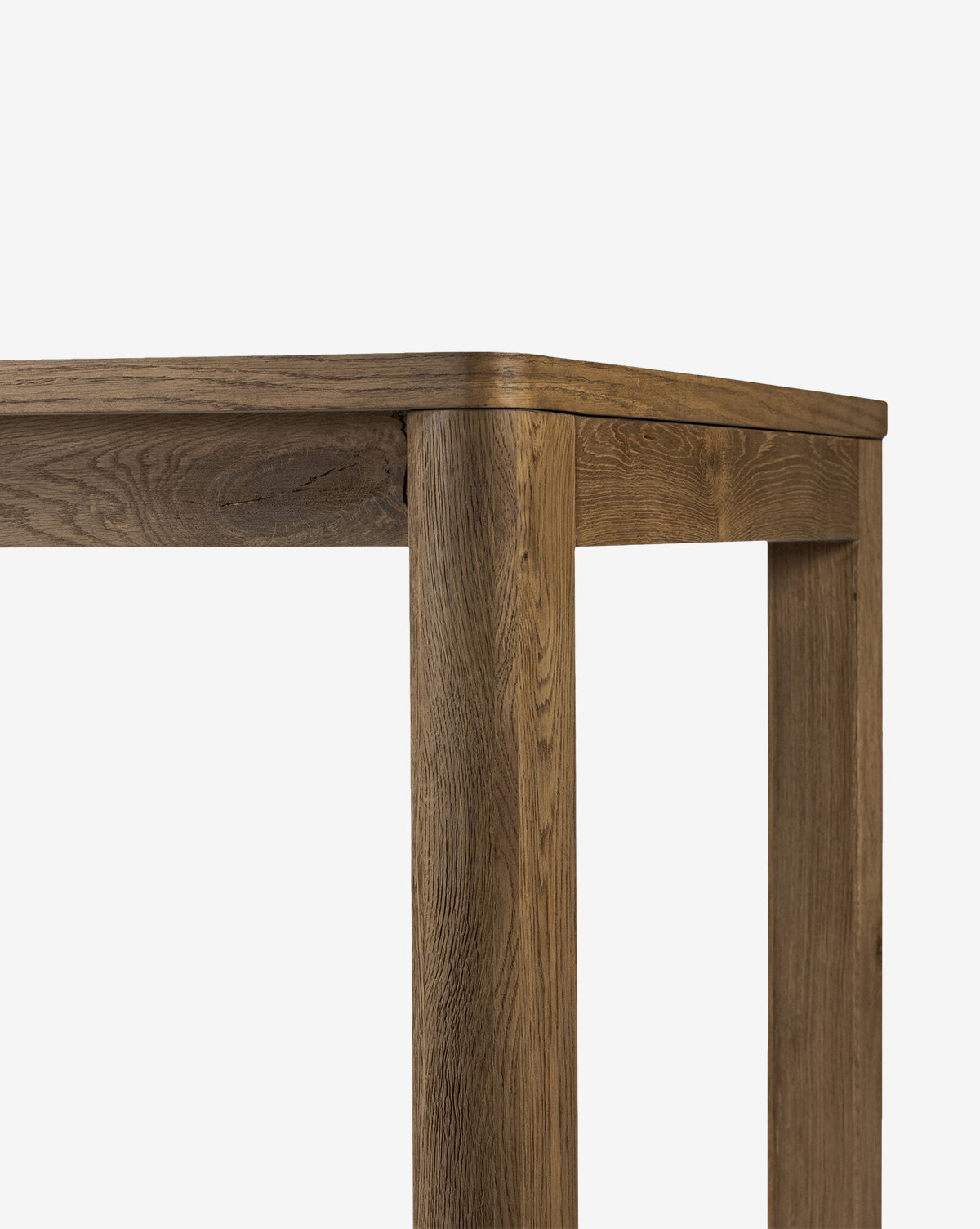 Close-up of the Wagner Extension Dining Table’s corner highlights its sturdy build and smooth oak grain finish, set against a plain white background by McGee & Co.