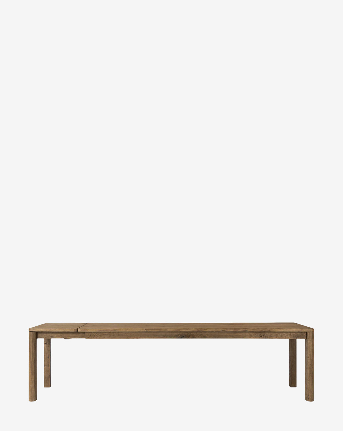 The Wagner Extension Dining Table is a simple, rectangular oak table with four straight legs and a natural wood finish, featuring a minimalist design, by McGee & Co.
