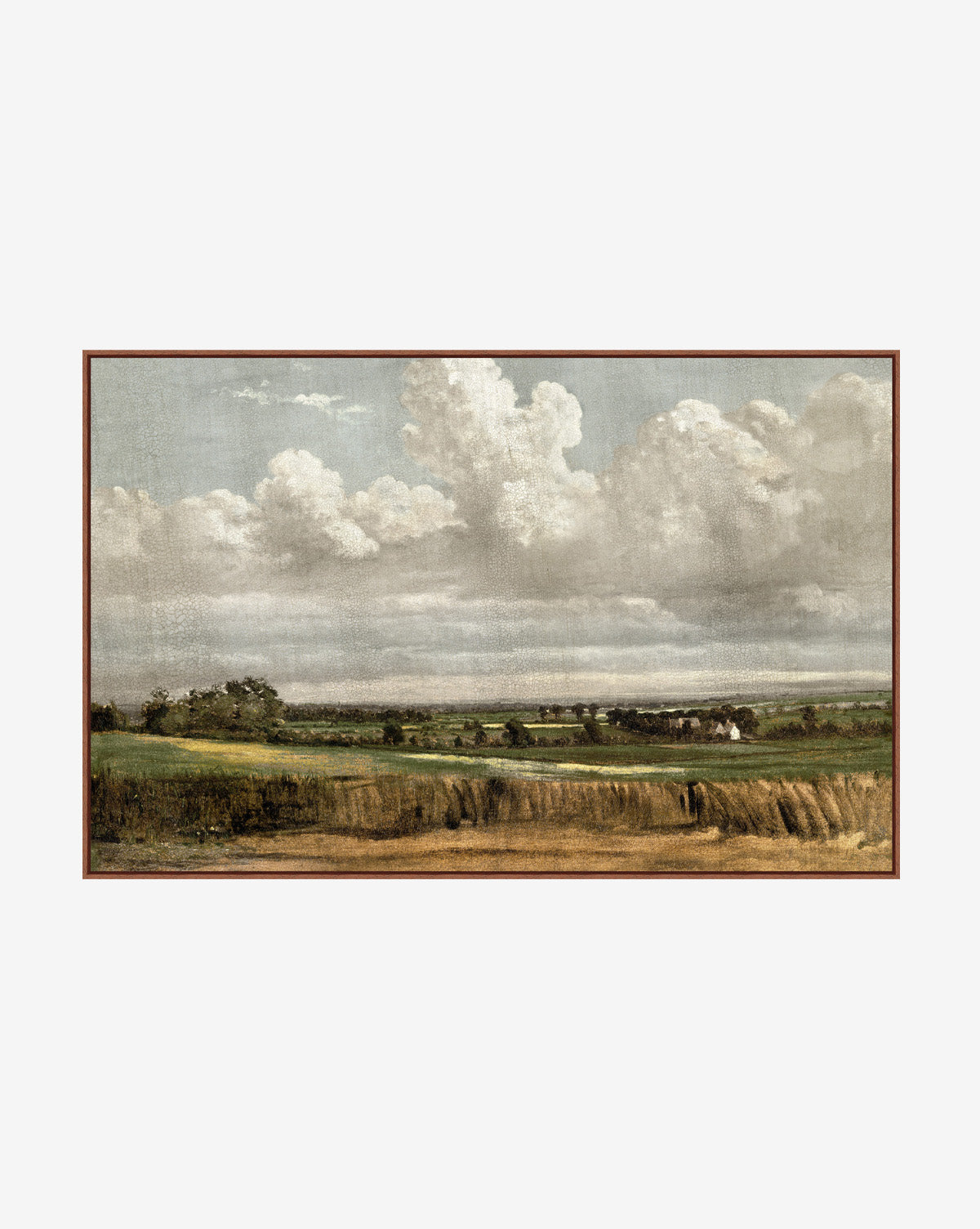 Wheatfield framed giclee print shows open fields, green trees, and distant houses beneath a cloudy blue sky. With earthy tones and a serene feel, its perfect as elegant canvas wall art to enhance your space by McGee & Co.