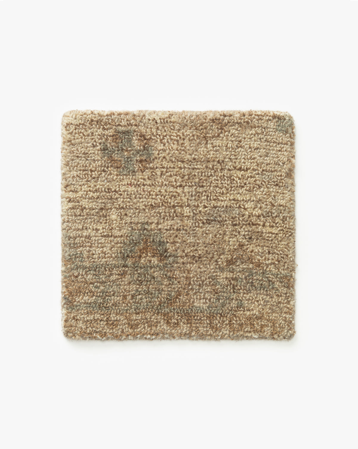 The Wilshire Natural Hand-Tufted Wool Rug Swatch is a rectangular, light brown rug with a textured, spill-resistant surface and subtle darker paw print patterns, displayed on a plain white background by McGee & Co.